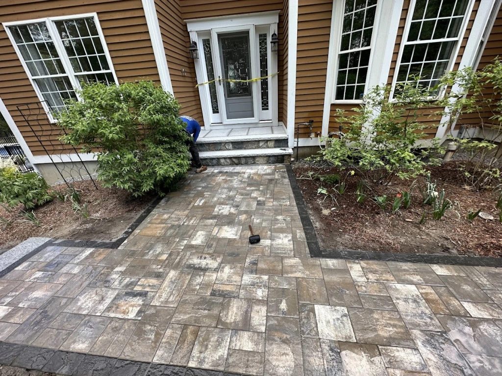 Grand entrance with pavers and granite steps